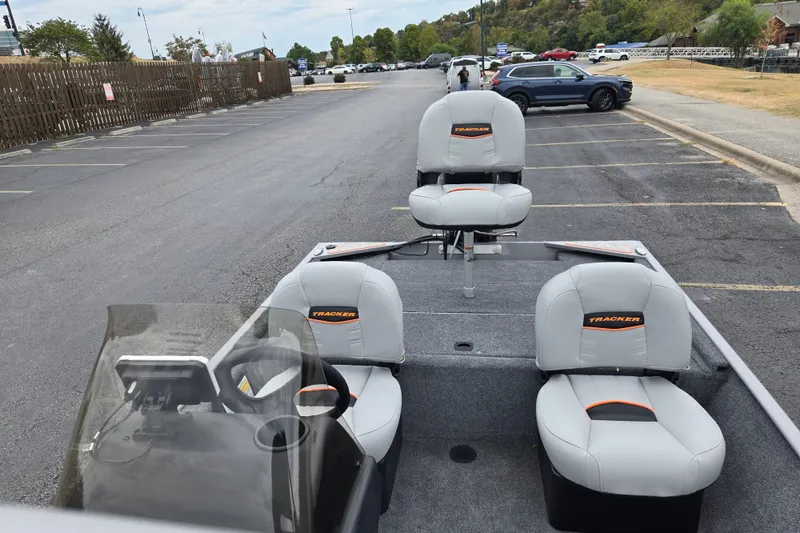 Slide: The Image of 2027 Tracker Bass Tracker Classic Limited boat with gray seating in a parking lot. - 17