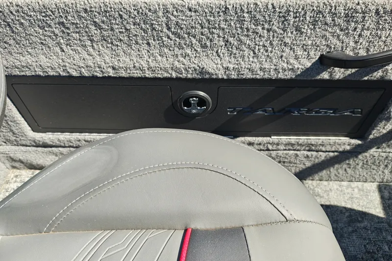 Slide: The Image of 2025 Tracker Targa V-18 WT interior detail with seat and storage compartment. - 29