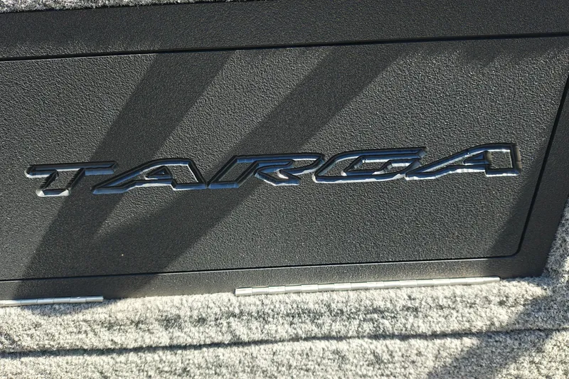 Slide: The Image of Close-up of 2025 Tracker Targa V-18 WT logo on textured surface. - 28