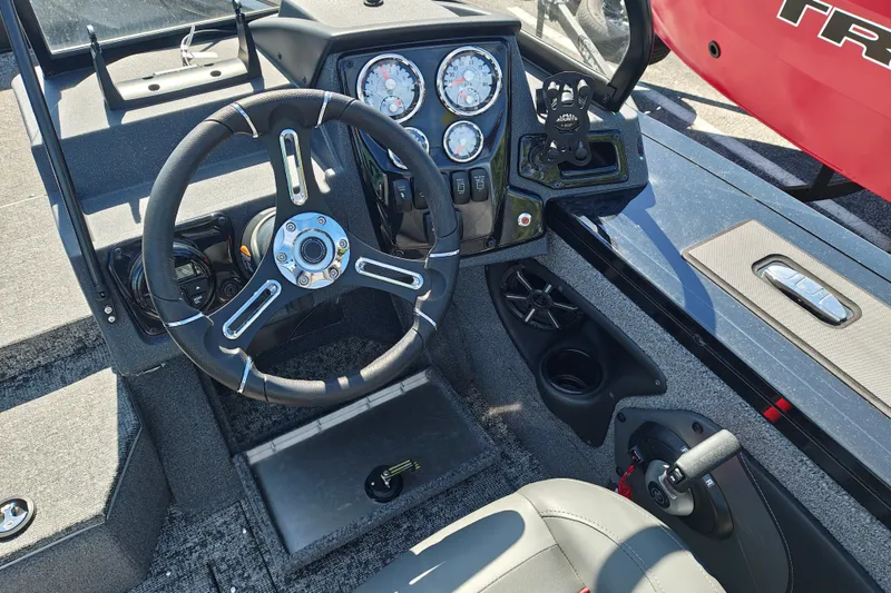Slide: The Image of 2025 Tracker Targa V-18 WT boat dashboard with steering wheel and control panel. - 31
