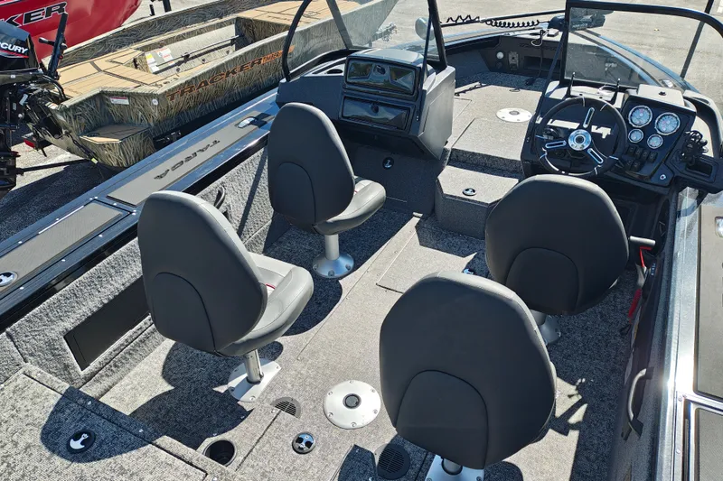 Slide: The Image of 2025 Tracker Targa V-18 WT boat interior with four seats and control panel. - 25