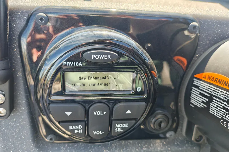 Slide: The Image of Close-up of a 2025 Tracker Targa V-18 WT boat control panel with display and buttons. - 34