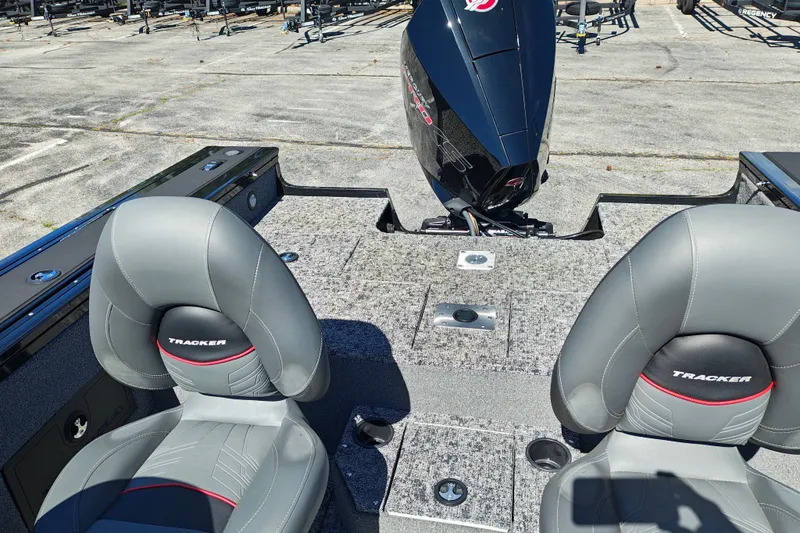 Slide: The Image of 2025 Tracker Targa V-18 WT boat interior with gray seats and motor. - 15