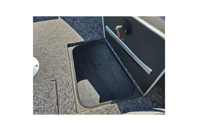 Slide: The Image of 2025 Tracker Targa V-18 WT boat storage compartment with carpeted interior. - 38