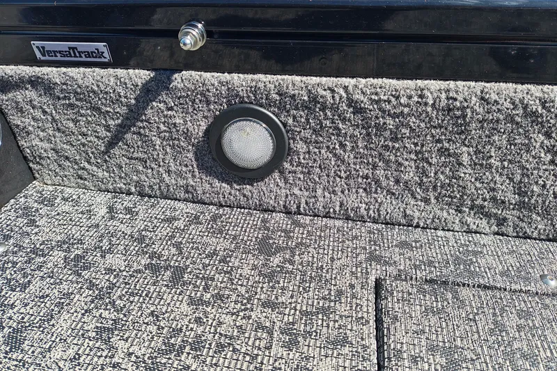Slide: The Image of 2025 Tracker Targa V-18 WT boat interior with VersaTrack system and textured flooring. - 26