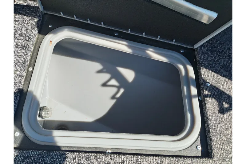 Slide: The Image of Open storage compartment on 2025 Tracker Targa V-18 WT boat. - 39