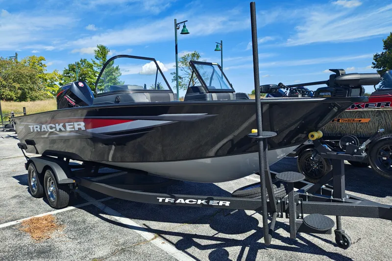 The Image of 2025 Tracker Targa V-18 WT boat on trailer, parked outdoors under blue sky. - 1