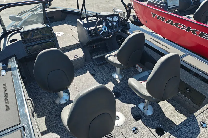 Slide: The Image of 2025 Tracker Targa V-18 WT boat interior with four seats and steering console. - 24