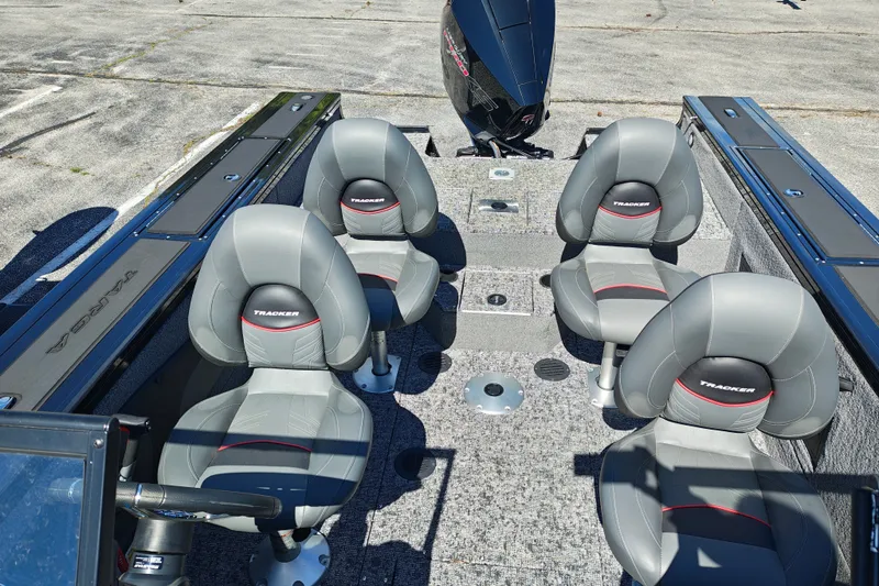 Slide: The Image of 2025 Tracker Targa V-18 WT boat interior with four gray seats and motor. - 14