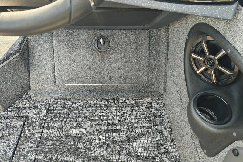 Slide: The Image of 2025 Tracker Targa V-18 WT interior with speaker and textured flooring. - 35