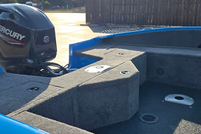 Slide: The Image of 2027 Tracker Pro Guide V-16 SC boat interior with Mercury engine, showcasing seating and storage. - 14