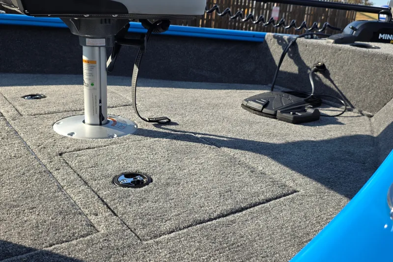 Slide: The Image of 2027 Tracker Pro Guide V-16 SC boat interior with carpeted deck and fishing seat. - 47