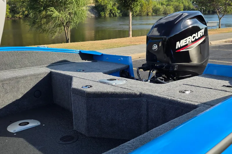 Slide: The Image of 2027 Tracker Pro Guide V-16 SC boat with Mercury engine by a riverside. - 13