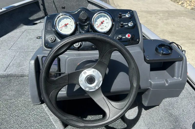 Slide: The Image of Steering console of 2027 Tracker Super Guide V-16 SC boat with gauges and controls. - 42