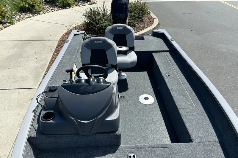 Slide: The Image of 2027 Tracker Super Guide V-16 SC boat interior with steering console and seating. - 40