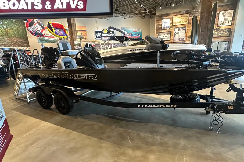 The Image of 2027 Tracker Pro Team 195 boat displayed in showroom with trailer. - 0