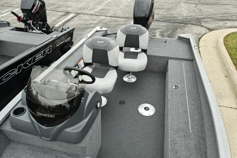 Slide: The Image of 2027 Tracker Super Guide V-16 SC boat interior with seating and steering console. - 24