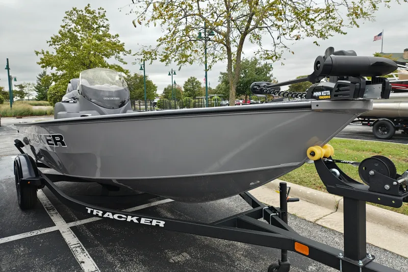 The Image of 2027 Tracker Super Guide V-16 SC boat on trailer, parked outdoors. - 0
