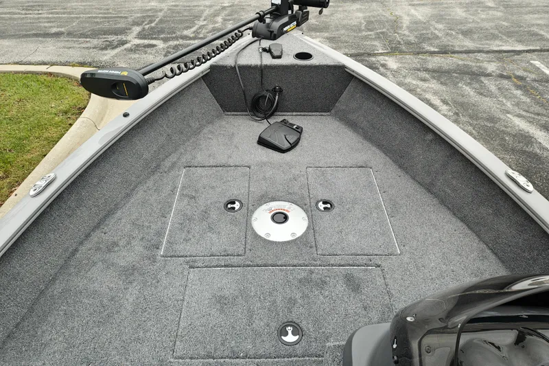 Slide: The Image of 2027 Tracker Super Guide V-16 SC boat interior with carpeted deck and trolling motor. - 18
