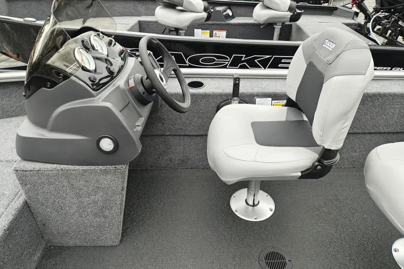 Slide: The Image of 2027 Tracker Super Guide V-16 SC boat interior with steering console and cushioned seat. - 15