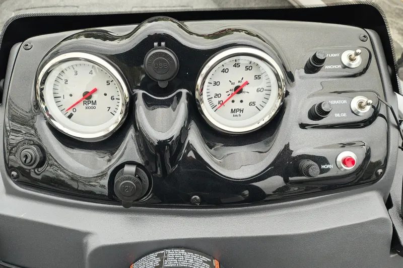 Slide: The Image of Dashboard of 2027 Tracker Super Guide V-16 SC with RPM and speed gauges. - 13