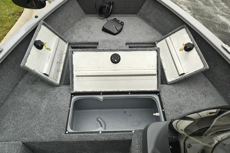Slide: The Image of 2027 Tracker Super Guide V-16 SC boat interior with storage compartments open. - 19