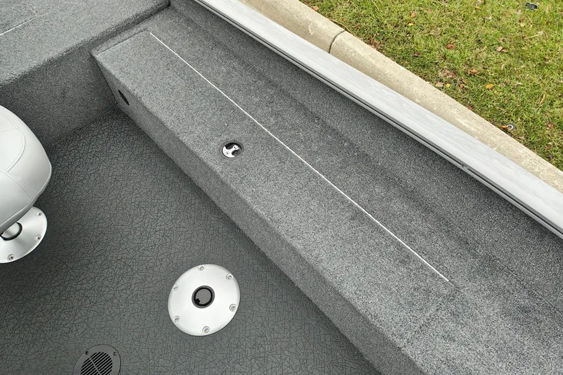 Slide: The Image of Interior view of 2027 Tracker Super Guide V-16 SC boat, featuring carpeted flooring and seating. - 25
