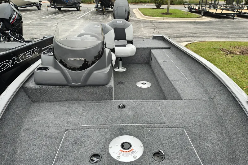 Slide: The Image of 2027 Tracker Super Guide V-16 SC boat interior with gray carpet and seating. - 23