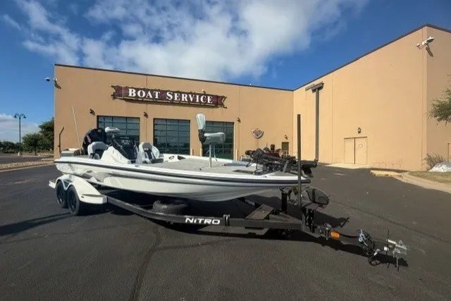 The Image of 2027 Nitro Z21 XL Pro boat on trailer outside service center. - 0