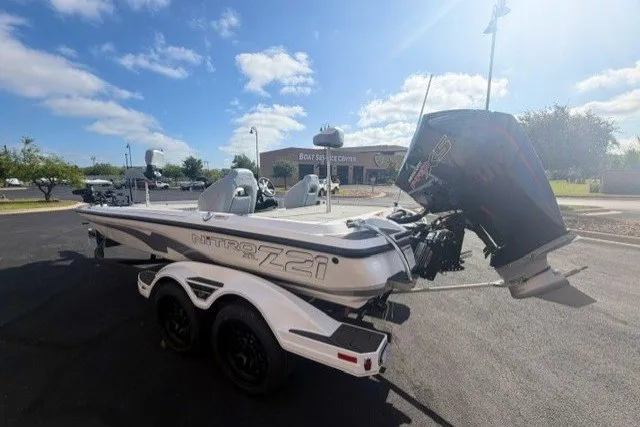 Slide: The Image of 2027 Nitro Z21 XL Pro boat with powerful outboard motor in sunny outdoor setting. - 3