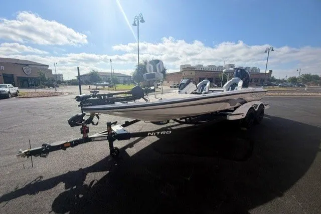 Slide: The Image of 2027 Nitro Z21 XL Pro boat on trailer in sunny parking lot. - 2