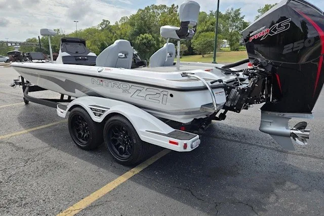 Slide: The Image of 2027 Nitro Z21 XL Pro boat with dual seats and powerful engine in a parking lot. - 4