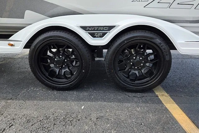 Slide: The Image of 2027 Nitro Z21 XL Pro trailer with sleek black wheels on asphalt. - 11