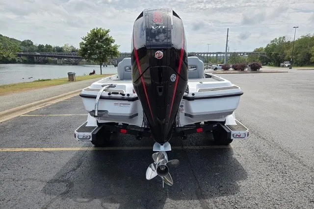 Slide: The Image of 2027 Nitro Z21 XL Pro boat with powerful outboard motor, parked near a scenic river. - 6