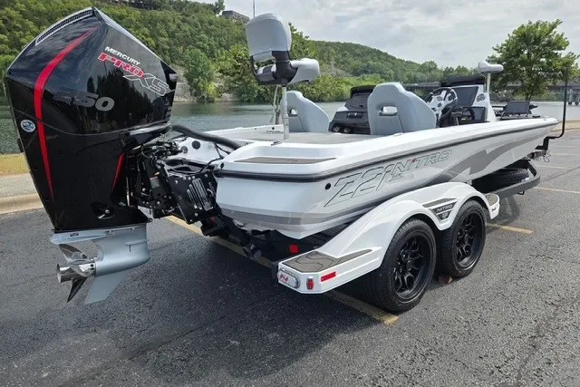 The Image of 2027 Nitro Z21 XL Pro boat with Mercury engine, parked near a scenic lake. - 3