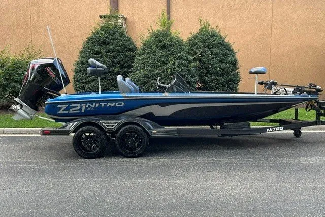 The Image of 2027 Nitro Z21 XL Pro boat on trailer, parked outdoors, side view. - 0