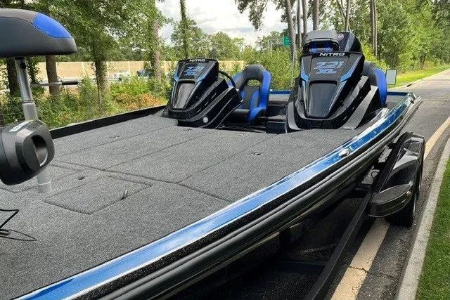 Slide: The Image of 2027 Nitro Z21 XL Pro boat with dual seats and sleek design on a wooded road. - 16