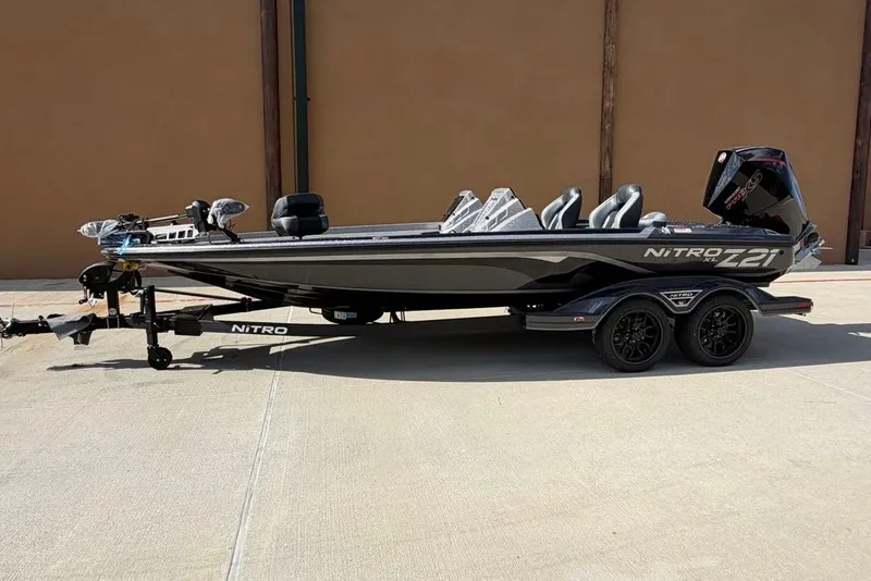 The Image of 2027 Nitro Z21 XL Pro boat on trailer, sleek design, parked outdoors. - 0