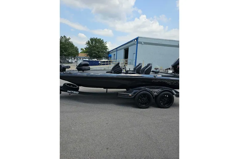The Image of 2027 Nitro Z19 XL Pro boat parked outdoors near a warehouse. - 0