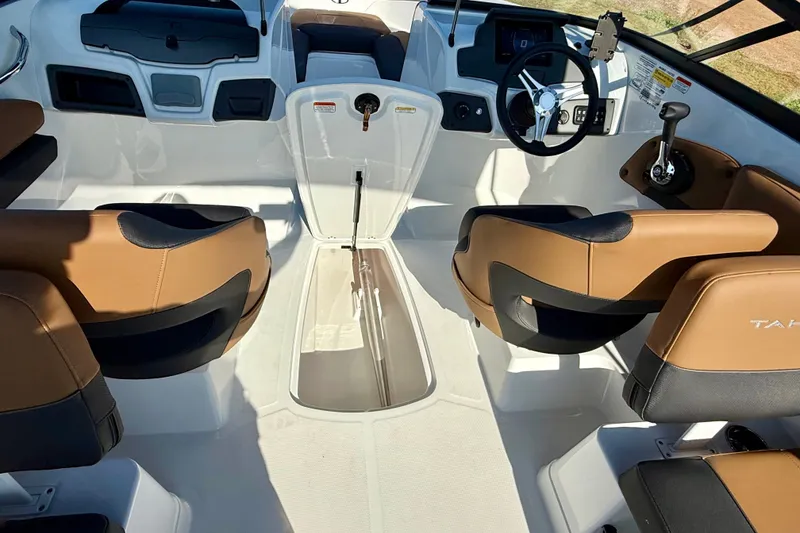 Slide: The Image of Interior of 2027 Tahoe 210 S boat with tan and black seating, modern controls. - 19
