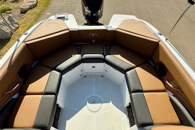 Slide: The Image of 2027 Tahoe 210 S boat interior with brown and black seating, spacious layout. - 17