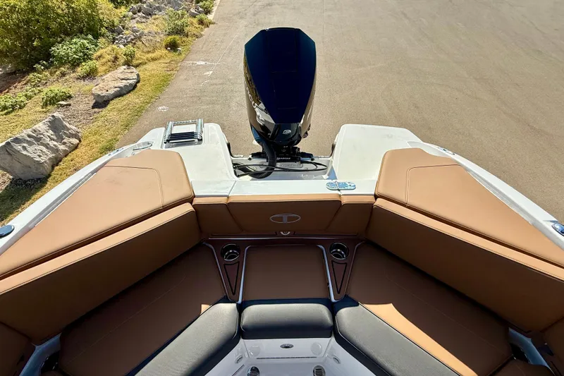 Slide: The Image of 2027 Tahoe 210 S boat interior with tan seating and outboard motor. - 20