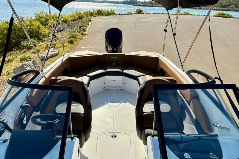 Slide: The Image of 2027 Tahoe 210 S boat interior with seating, steering wheel, and scenic waterfront view. - 15