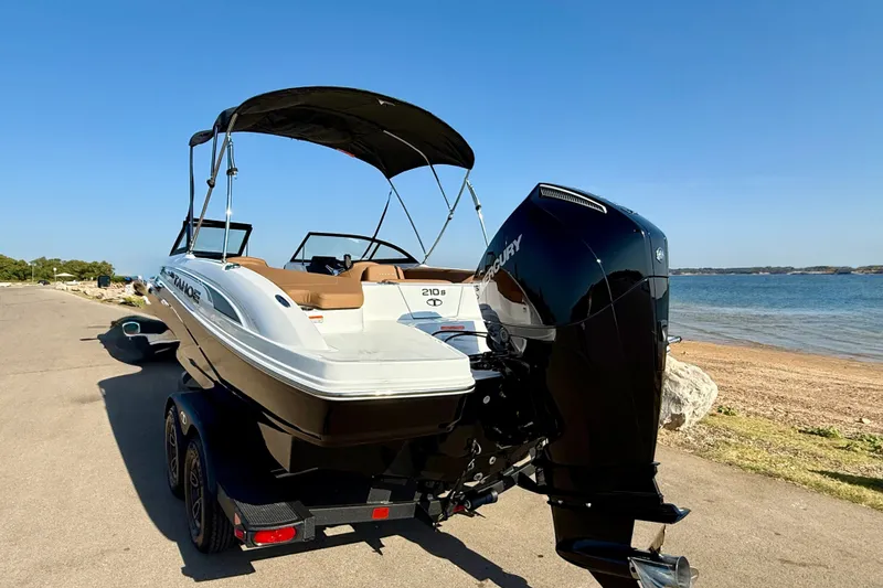 Slide: The Image of 2027 Tahoe 210 S boat with Mercury engine on trailer by the beach. - 22
