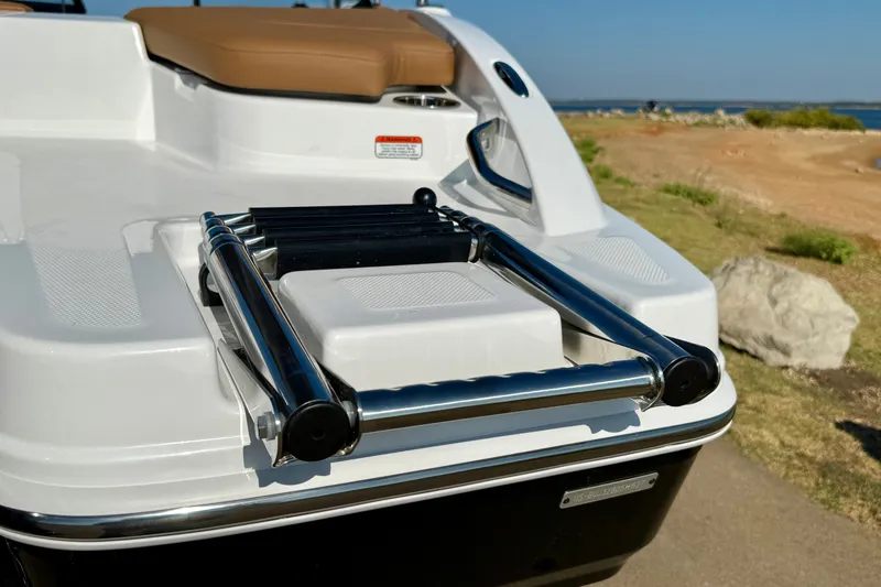 Slide: The Image of 2027 Tahoe 210 S boat with a sleek swim platform and foldable ladder. - 25