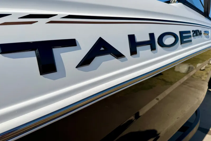 Slide: The Image of Close-up of 2027 Tahoe 210 S boat logo on sleek white surface. - 26