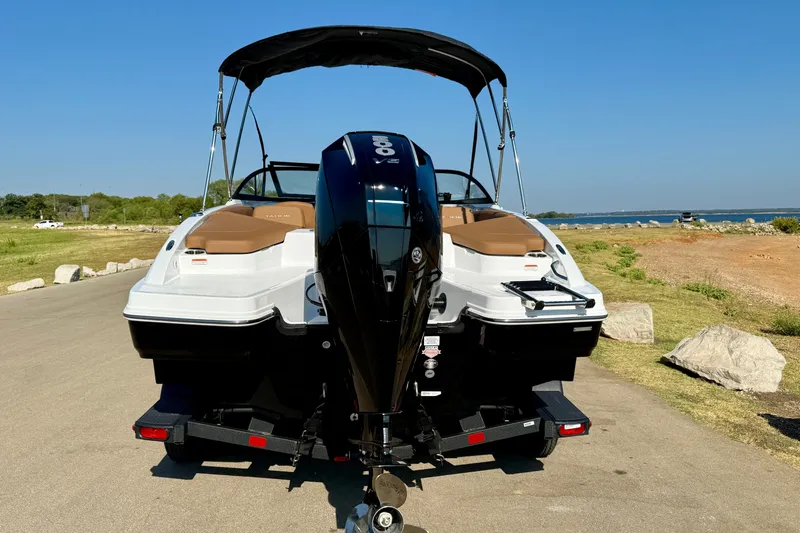 Slide: The Image of 2027 Tahoe 210 S boat with outboard motor on trailer by lakeside. - 24