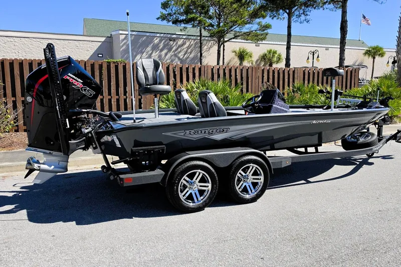 Slide: The Image of 2026 Ranger ALPHA 208 boat on trailer, parked outdoors, featuring sleek design and powerful engine. - 3