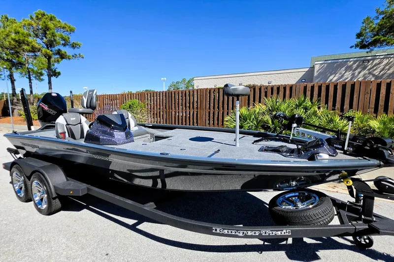 Slide: The Image of 2026 Ranger ALPHA 208 fishing boat on trailer, parked outdoors under clear blue sky. - 10
