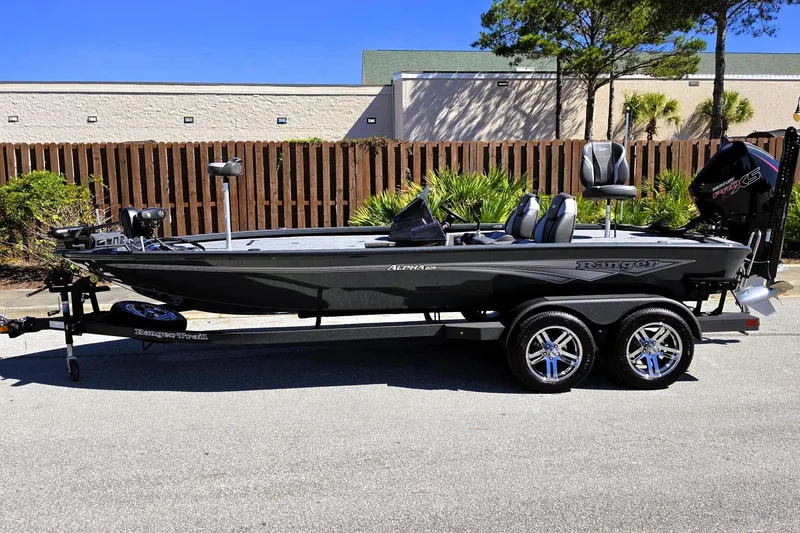 Slide: The Image of 2026 Ranger ALPHA 208 boat on trailer, parked outdoors, showcasing sleek design and modern features. - 11
